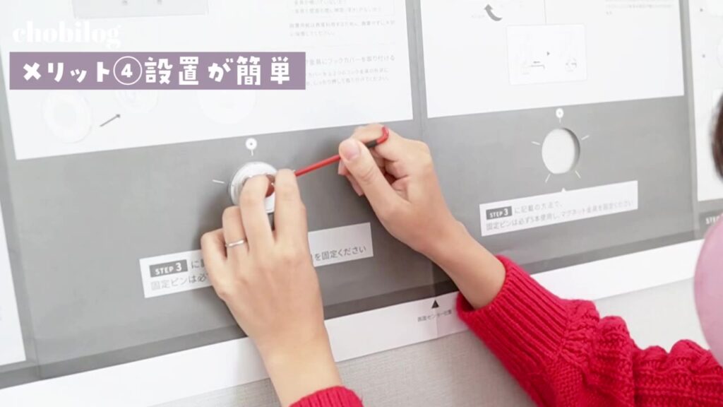 説明書の上から壁掛けテレビの金具を取り付ける手元