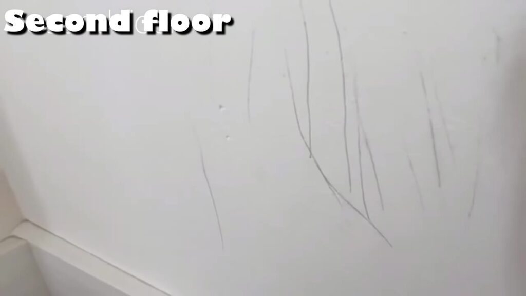 階段の壁紙に残ったボールペンの落書き